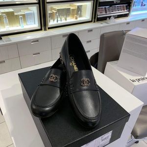 Chanel loafers with gold chain